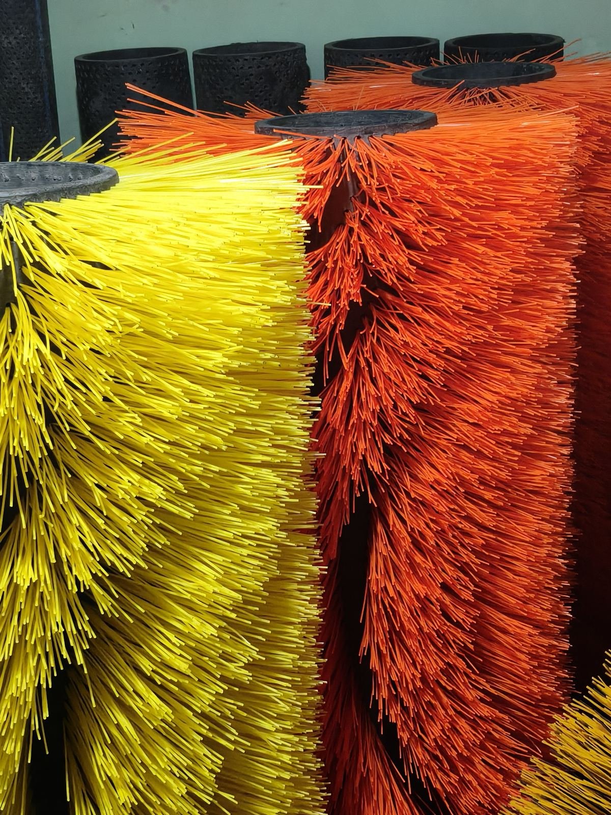 Yellow and orange polypropylene road sweeper centre brushes with perforated tube cores